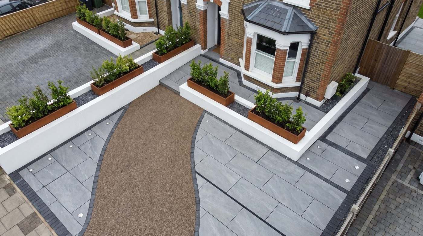 Aerial view of precision laid porcelain paving, resin driveway and retaining walls